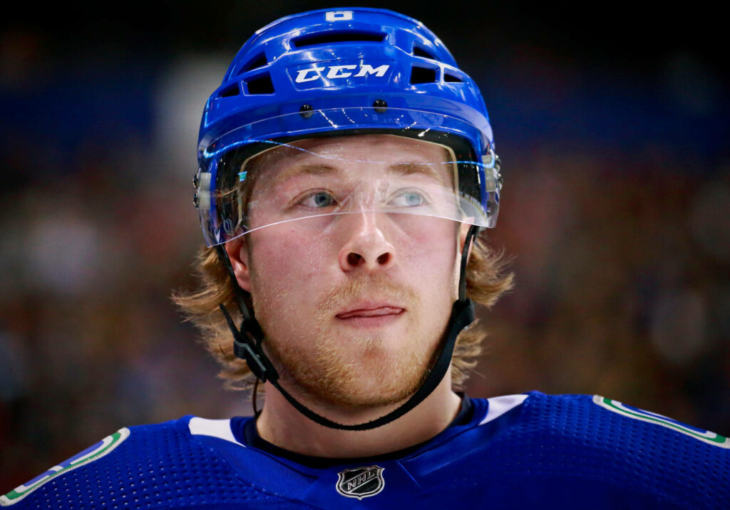 Brock Boeser Vancouver Canucks NHL player intense game action vibrant team colors wallpaper