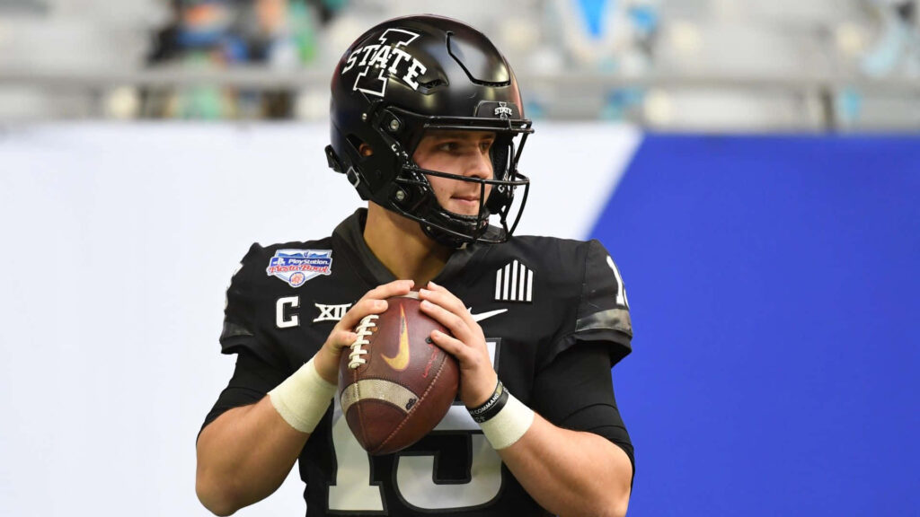 Brock Purdy Iowa State quarterback in black uniform ready to pass stadium background wallpaper