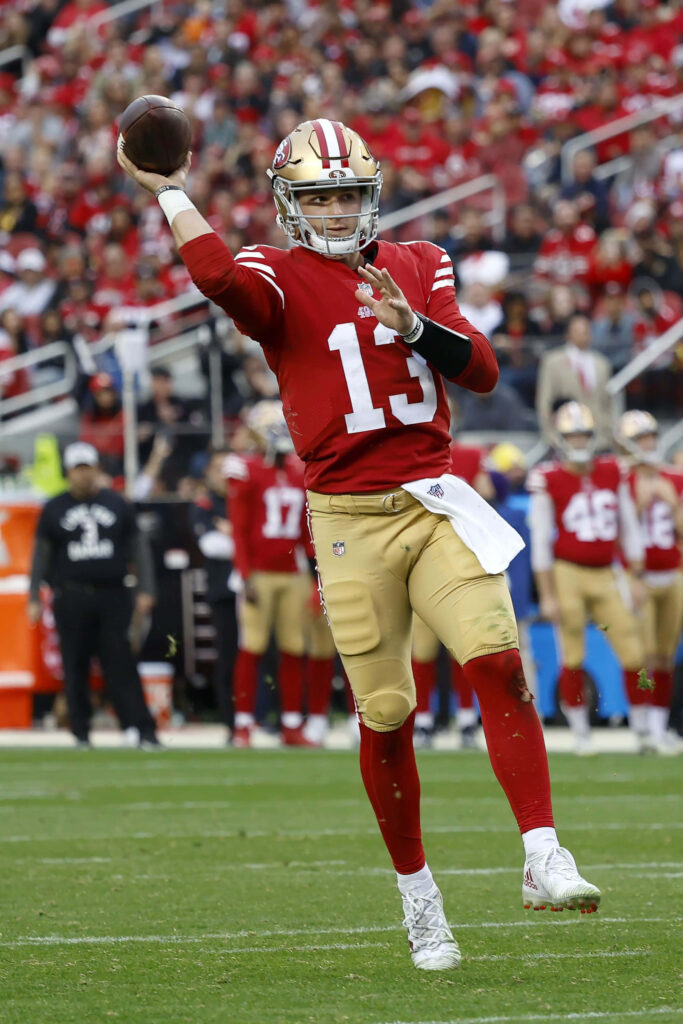 Brock Purdy San Francisco 49ers quarterback throwing football in action vibrant stadium wallpaper