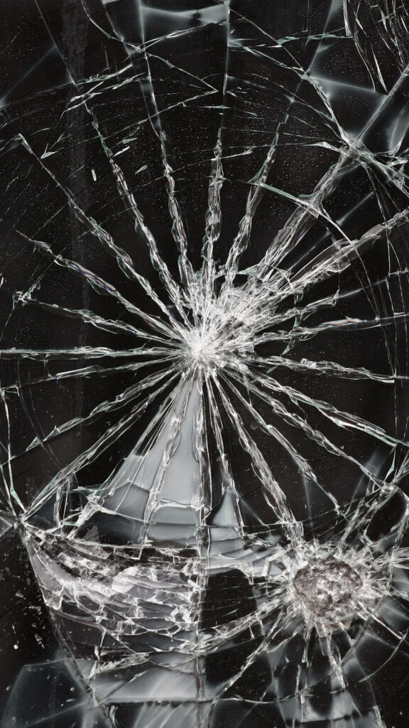 Broken glass screen dark wallpaper with detailed shattered cracks on black background for devices