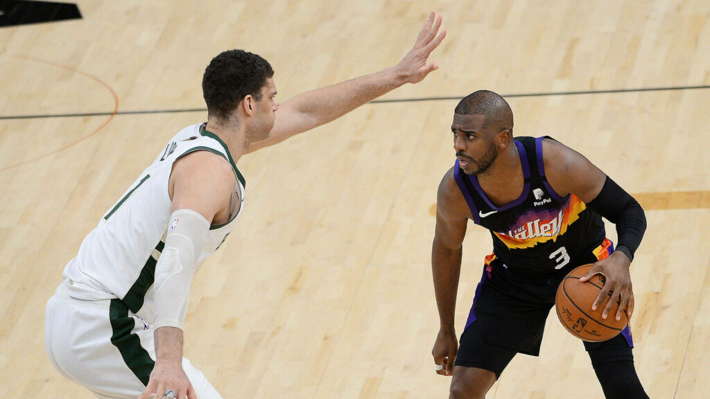 Brook Lopez defends Chris Paul in Milwaukee Bucks vs Phoenix Suns NBA basketball action wallpaper