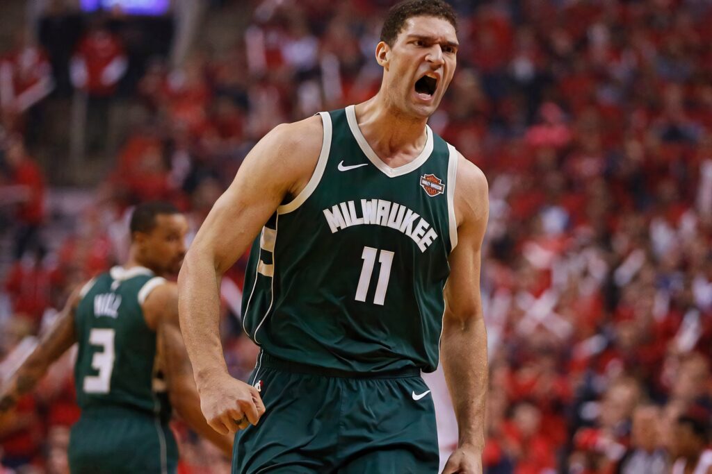 Brook Lopez Milwaukee Bucks number 11 intense action mid-shout vibrant game crowd background wallpaper