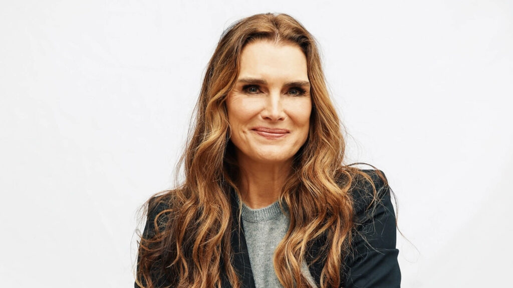 Brooke Shields portrait with wavy brown hair soft makeup gentle smile white background wallpaper