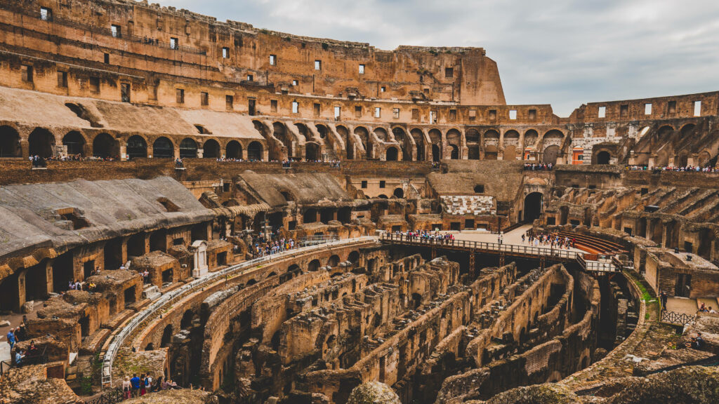 Brown Colosseum interior wallpaper showing ancient Rome arches stone architecture sunlight