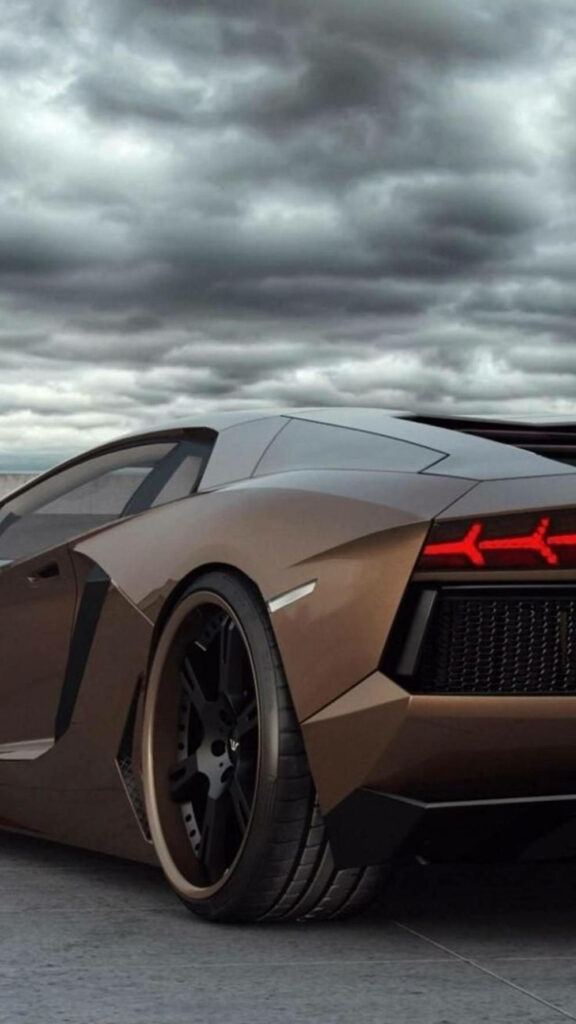 Sleek brown Lamborghini under dramatic dark clouds luxury car wallpaper background for iPhone