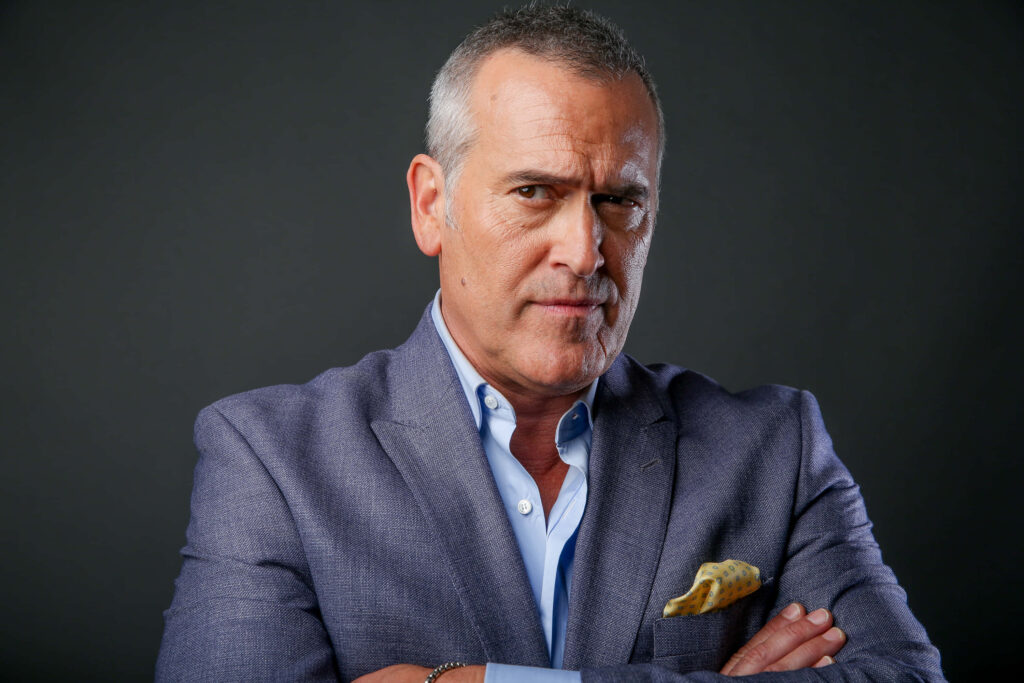 Bruce Campbell sharp studio portrait gray blazer minimalist dark background fan wallpaper