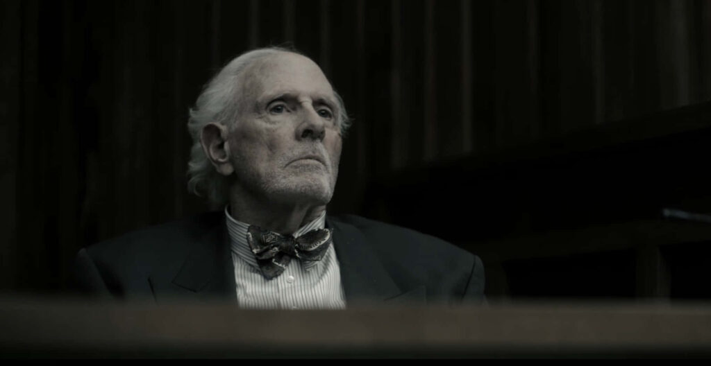 Bruce Dern dramatic courtroom portrait wallpaper dark lighting formal attire cinematic mood