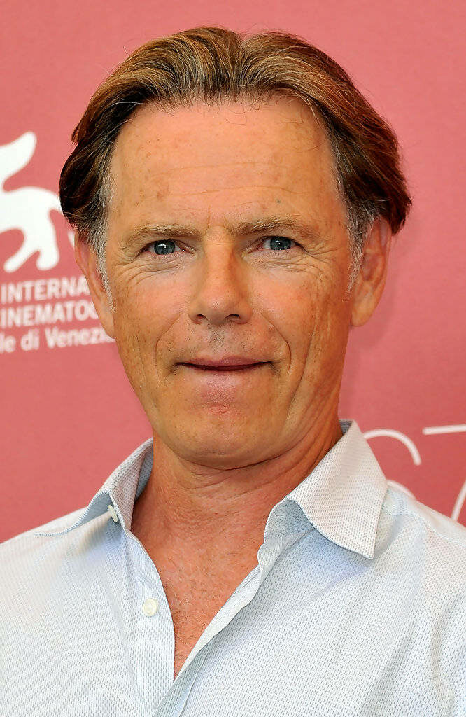Close-up portrait of actor Bruce Greenwood with warm red background high-resolution wallpaper
