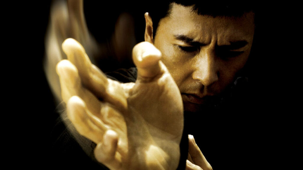 Bruce Lee close-up action pose intense focus martial arts energy dramatic lighting HD wallpaper