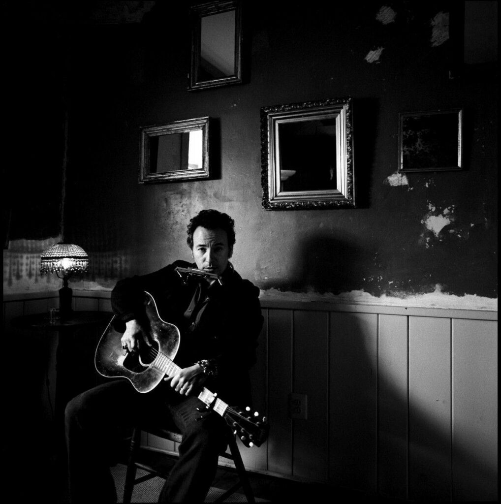Bruce Springsteen black and white portrait with acoustic guitar vintage Americana concert wallpaper