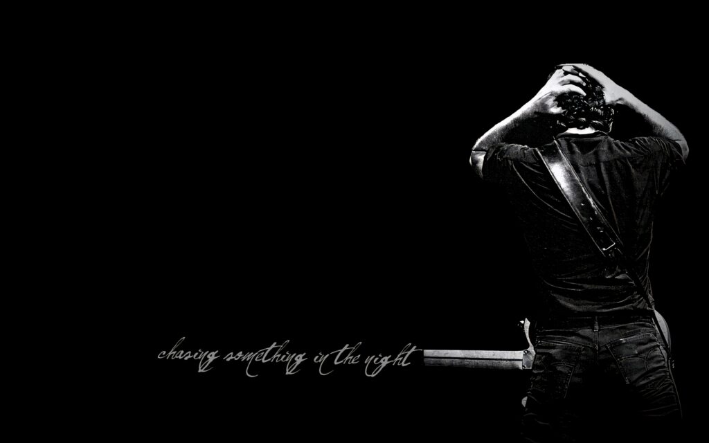 Black and white Bruce Springsteen wallpaper with iconic guitar and moody minimalist portrait