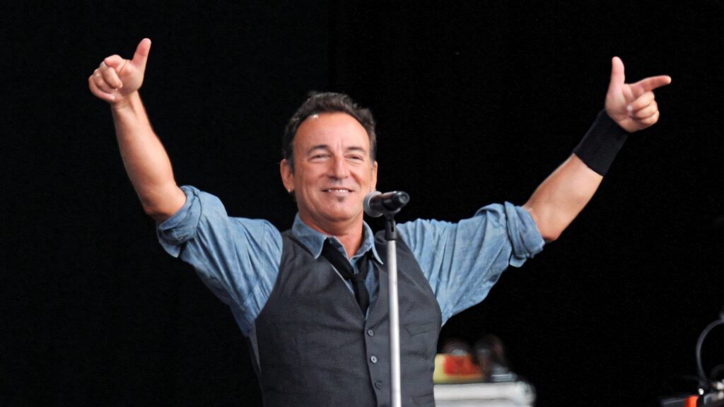 Bruce Springsteen live benefit concert wallpaper energetic performance classic rock style