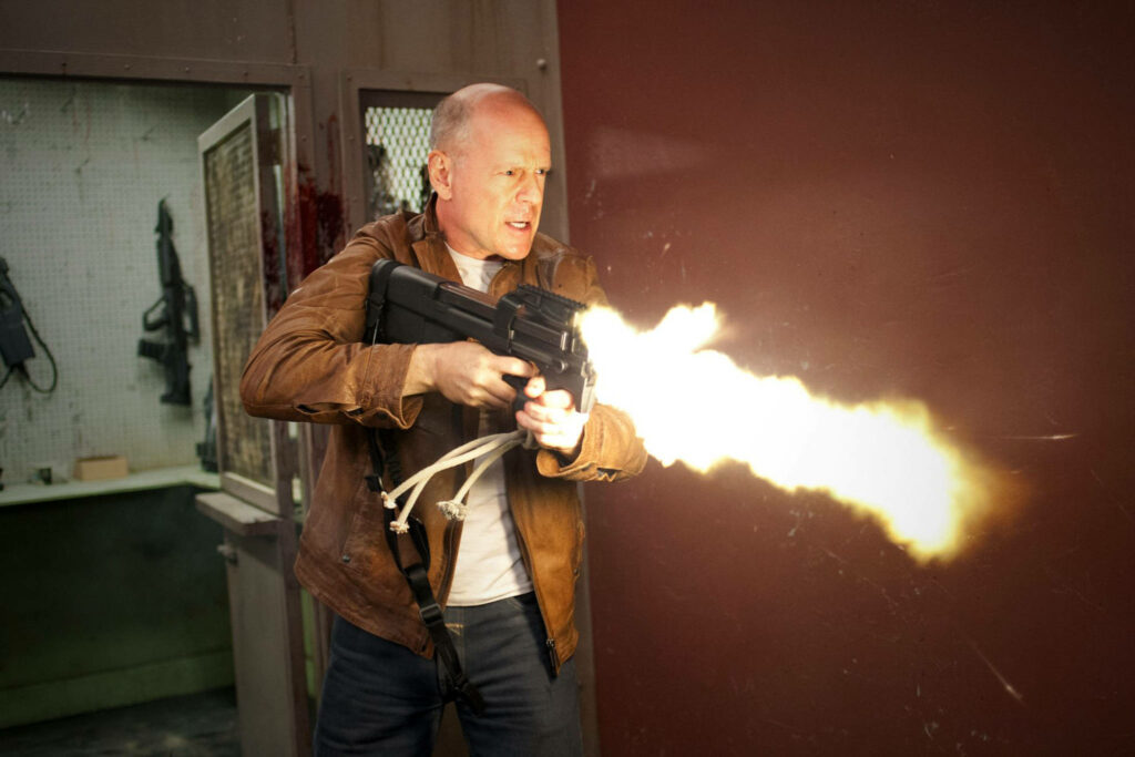 Bruce Willis firing weapon in intense action scene wallpaper capturing high stakes thrill