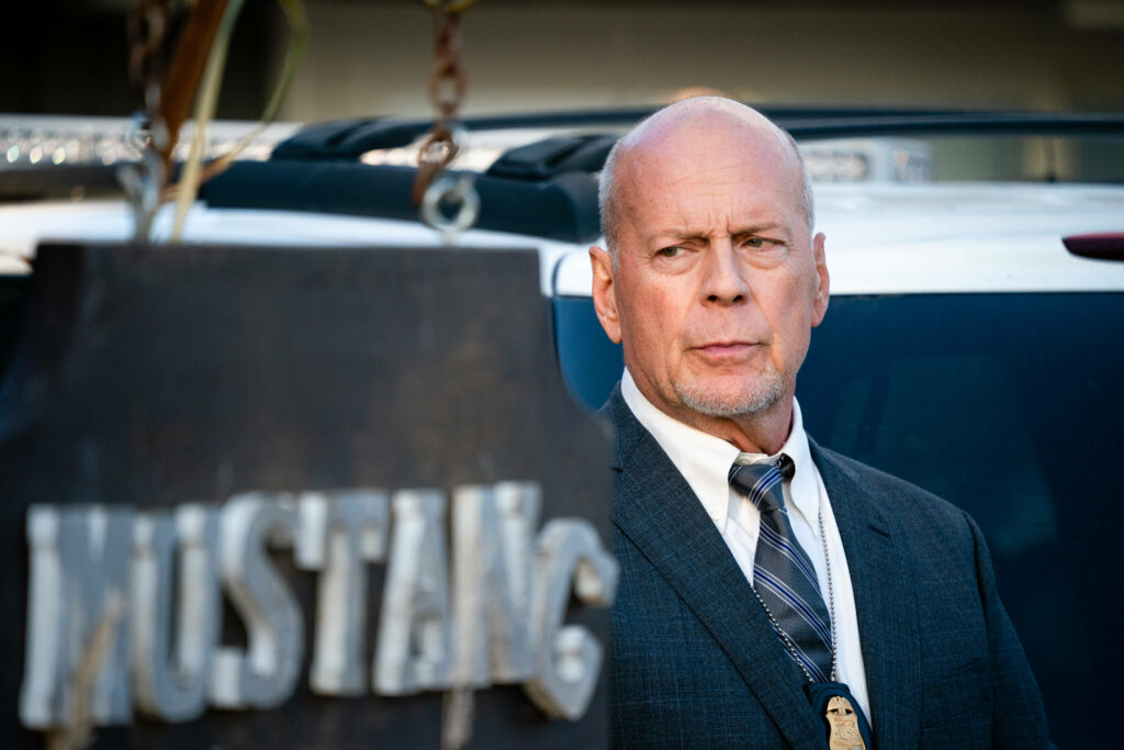 Bruce Willis as serious FBI agent in suit and tie intense dramatic wallpaper background