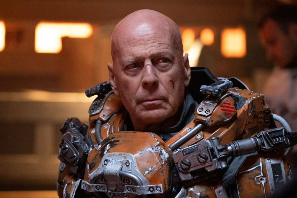 Bruce Willis in futuristic armor with cosmic sun glow intense space adventure wallpaper background