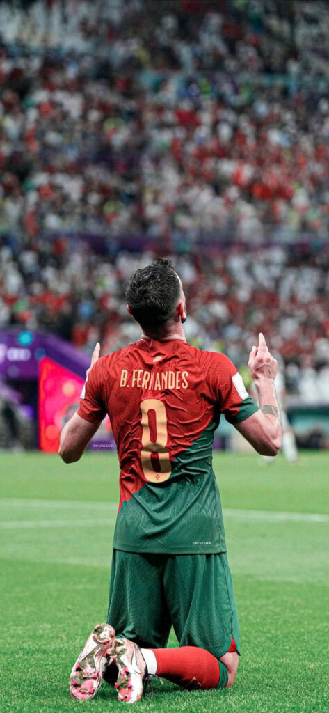 Bruno Fernandes celebrating in Portugal kit vibrant stadium background high resolution football wallpaper