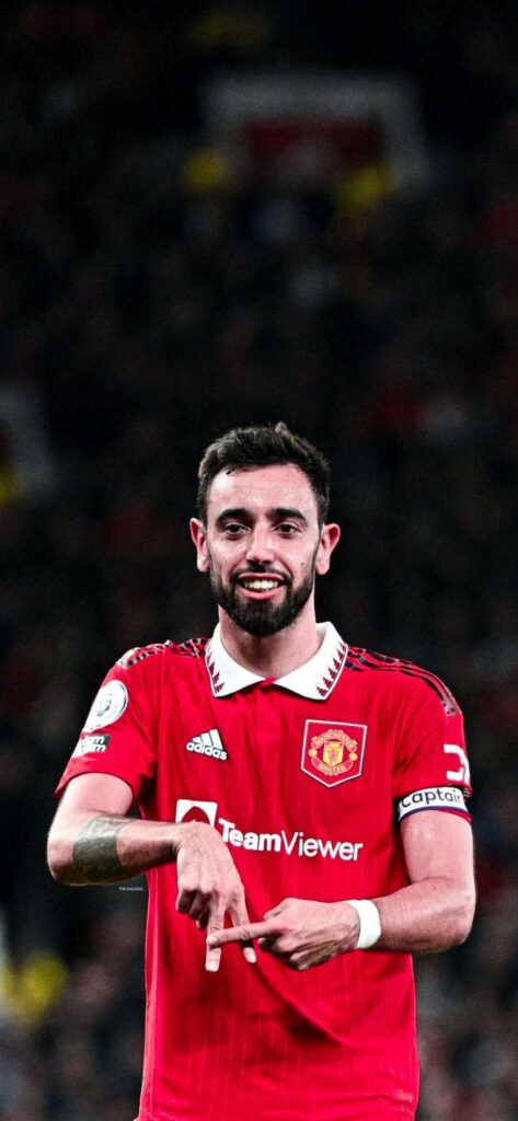 Bruno Fernandes Manchester United midfielder red jersey goal celebration stadium background wallpaper