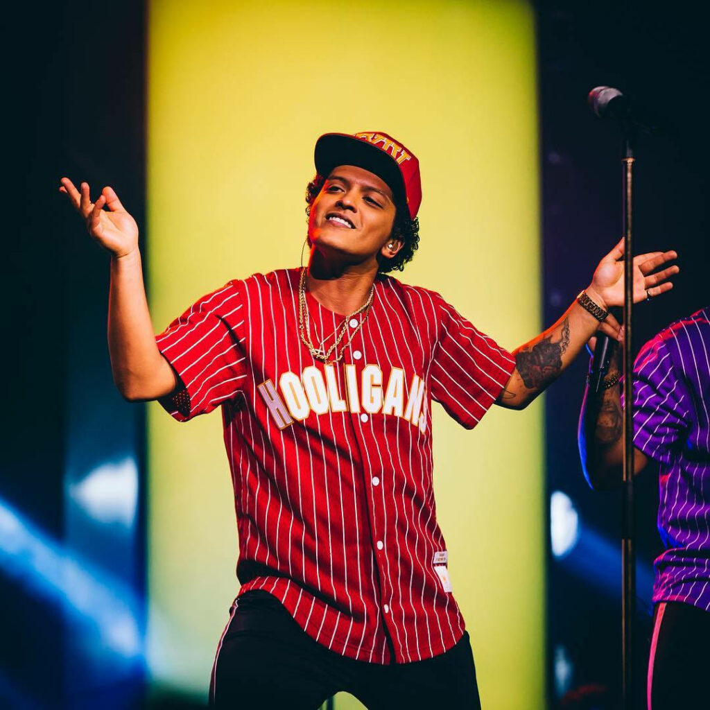 Bruno Mars live performance vibrant red Hooligans jersey dynamic colorful concert energy wallpaper