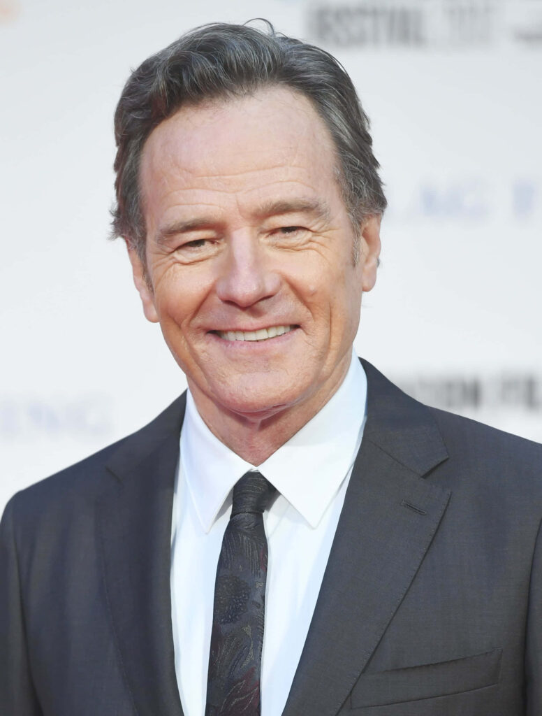 High-resolution Bryan Cranston portrait in black suit with confident smile and blurred background Wallpaper