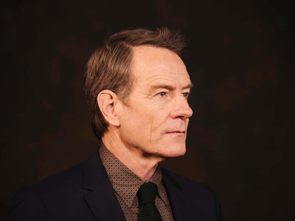 Bryan Cranston profile portrait in patterned shirt and suit dark background stylish celebrity wallpaper