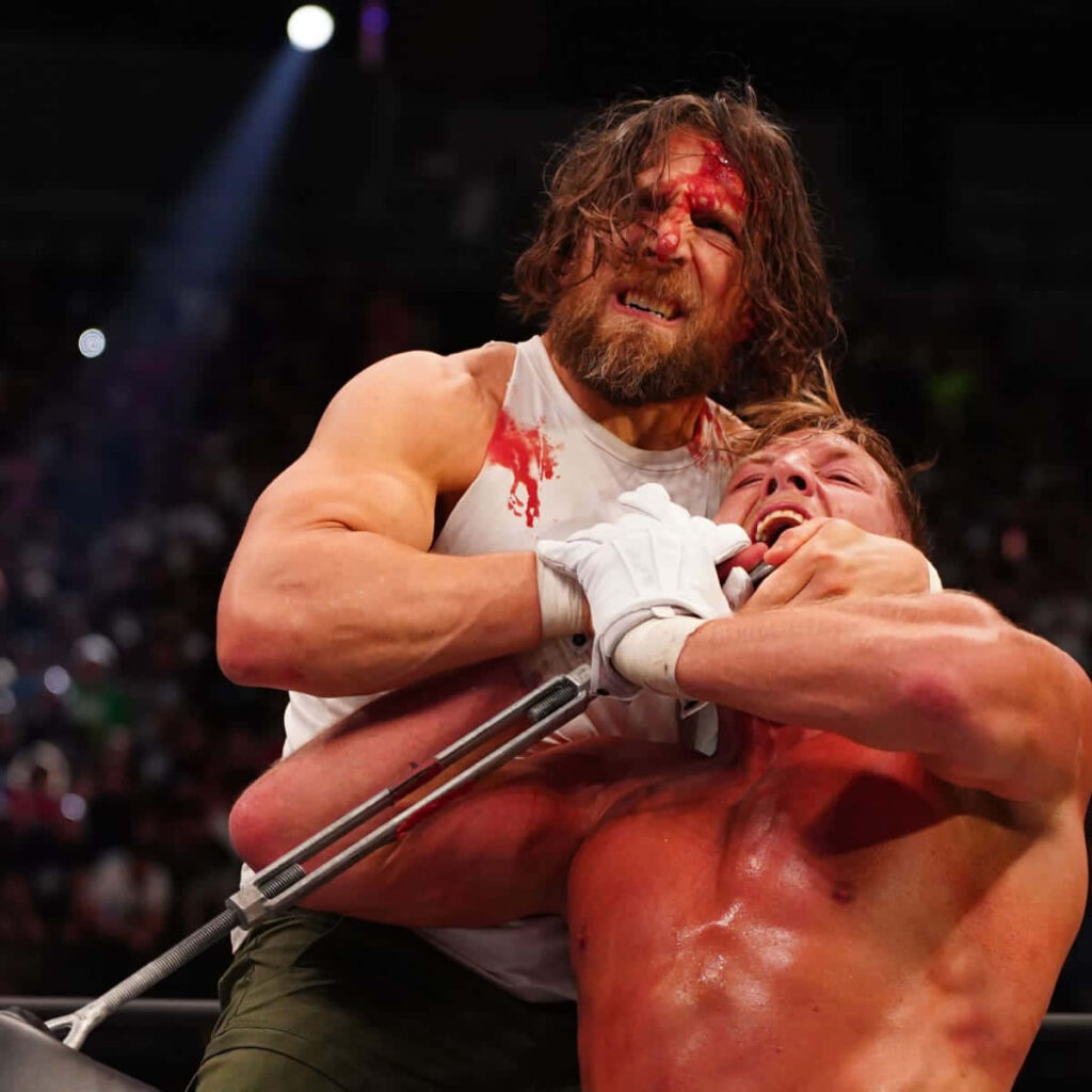Bryan Danielson performing powerful choke hold wrestling move in dynamic arena with spotlight Wallpaper