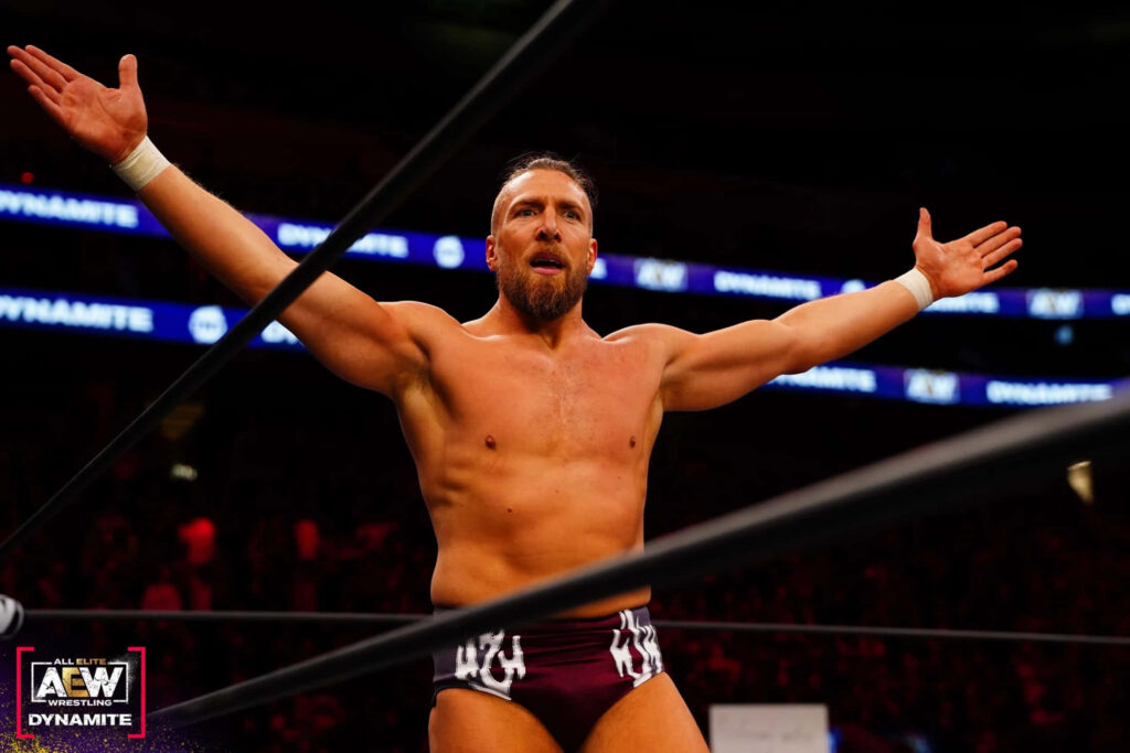 Bryan Danielson WWE wrestler victorious in ring with dramatic lighting and energetic crowd background Wallpaper