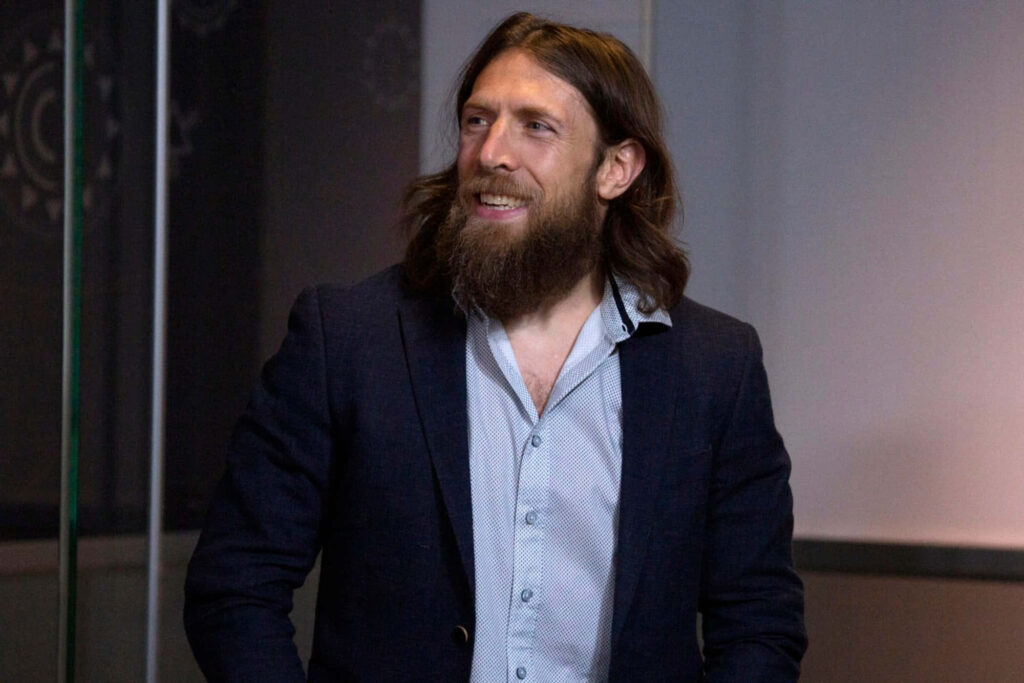 Bryan Danielson American wrestler candid portrait in dark blazer with long hair and beard wallpaper