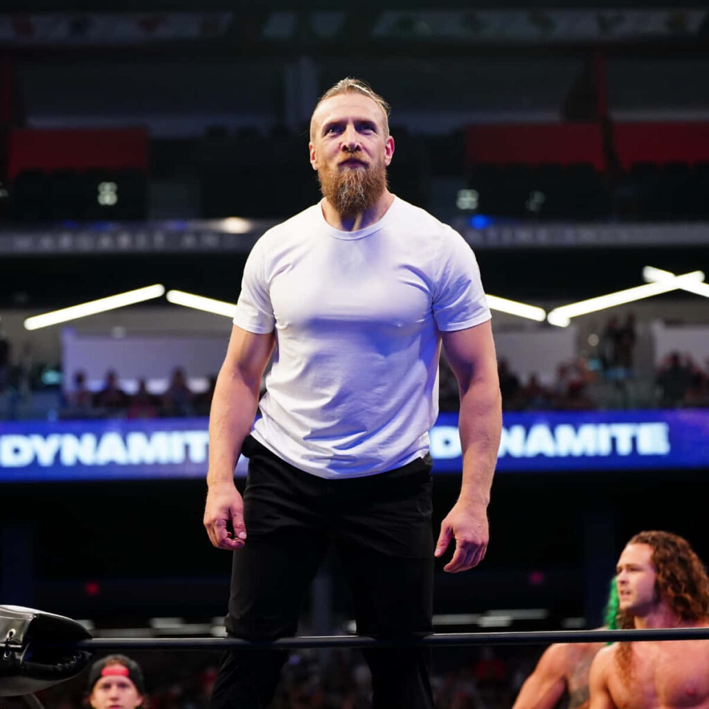 Bryan Danielson wrestling wallpaper with multi-title champion in ring wearing white shirt and black pants