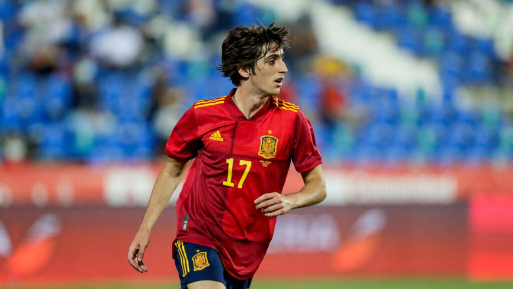 Bryan Gil in Spain red jersey number 17 in action football wallpaper high resolution stadium background
