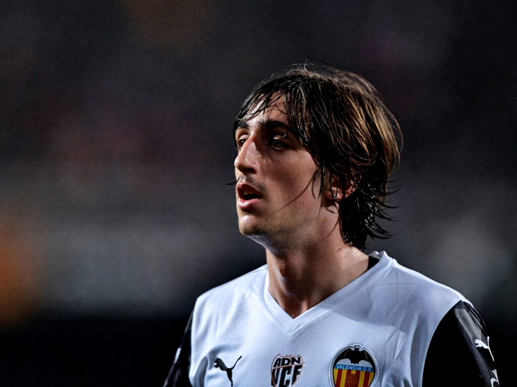 Bryan Gil in white Valencia CF jersey focused during match under stadium lights wallpaper