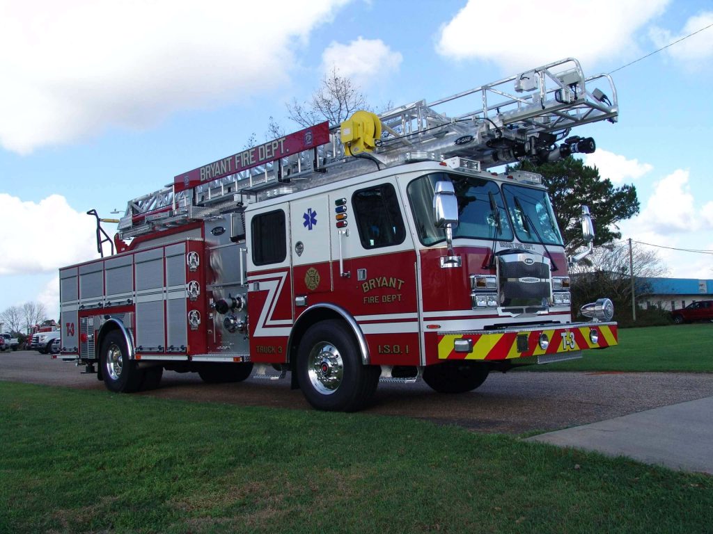 Bryant Fire Department E-ONE ladder truck side view on bright day with blue sky background Wallpaper