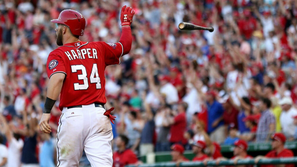 Bryce Harper in red jersey number 34 bat flip with cheering crowd stadium MLB wallpaper background