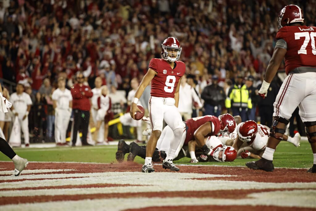 Bryce Young Alabama quarterback confident in end zone vibrant stadium lights high definition action Wallpaper