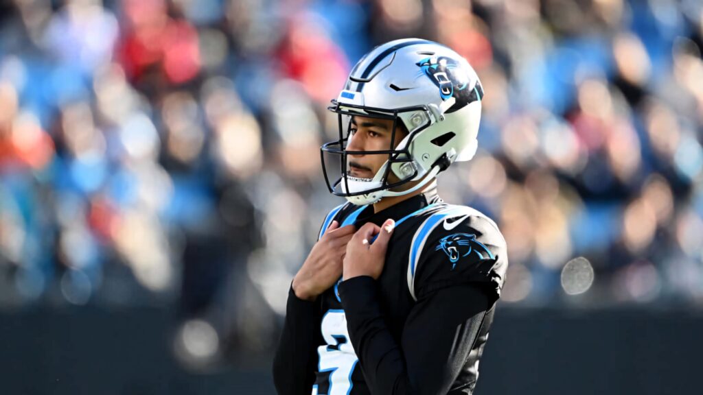 Bryce Young Carolina Panthers quarterback in vibrant stadium wearing official blue and silver uniform Wallpaper