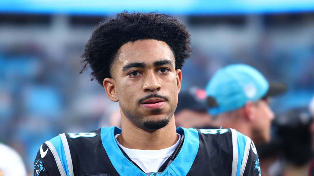 Bryce Young in Carolina Panthers black and blue jersey with vibrant stadium background wallpaper