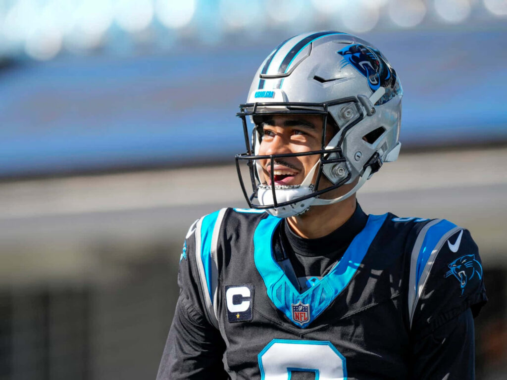 Bryce Young smiling in Carolina Panthers uniform vibrant blue black NFL football wallpaper background