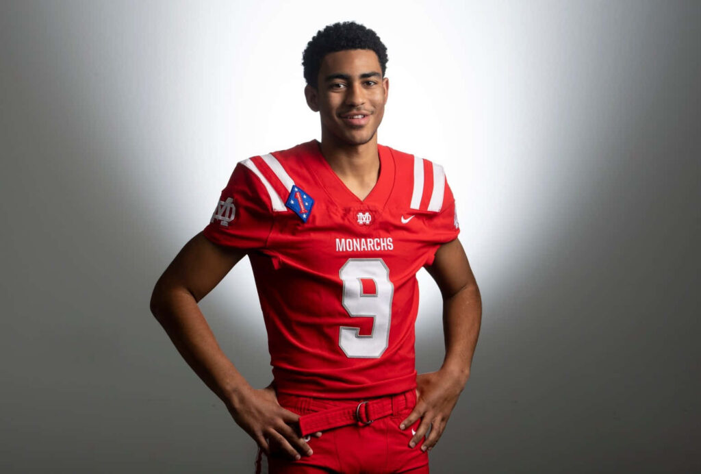 Bryce Young in red Monarchs football uniform portrait wallpaper bold inspiring sports background