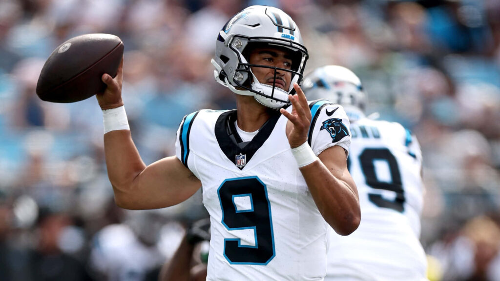Bryce Young Panthers quarterback in white jersey throwing football dynamic NFL game action wallpaper