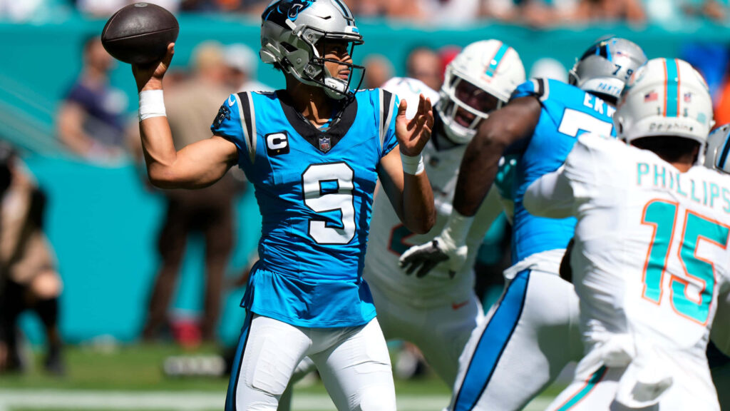 Bryce Young Panthers quarterback mid-throw in Carolina Panthers uniform NFL game action wallpaper