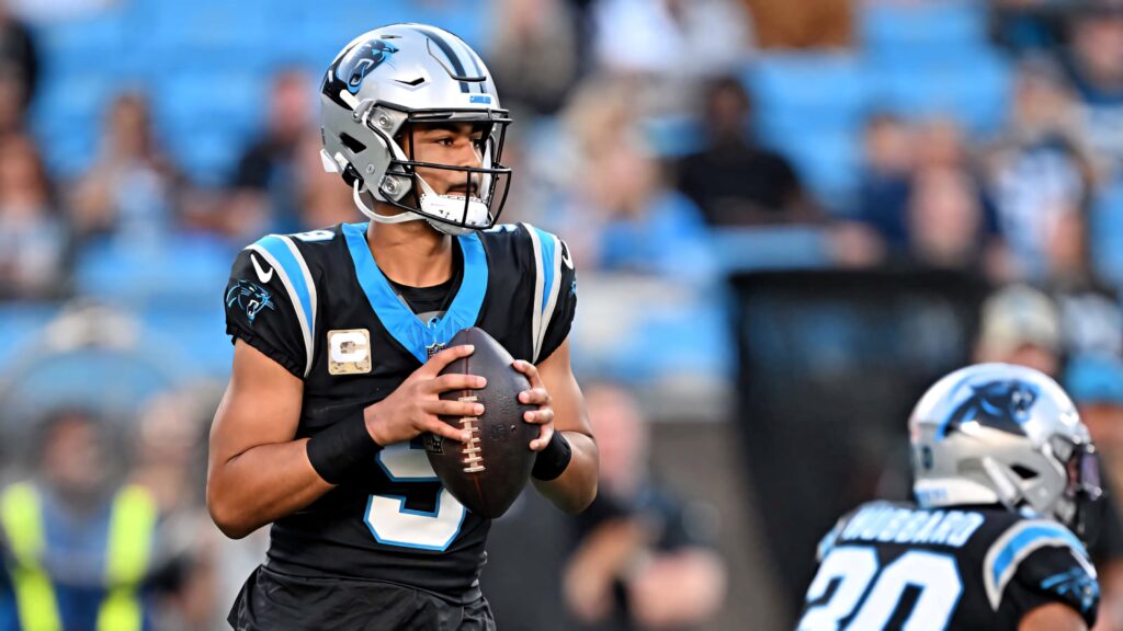 Bryce Young Panthers quarterback mid-play in Carolina Panthers uniform vibrant stadium NFL wallpaper