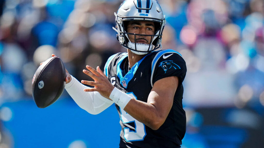 Bryce Young Panthers quarterback throwing football in dynamic Carolina Panthers game wallpaper