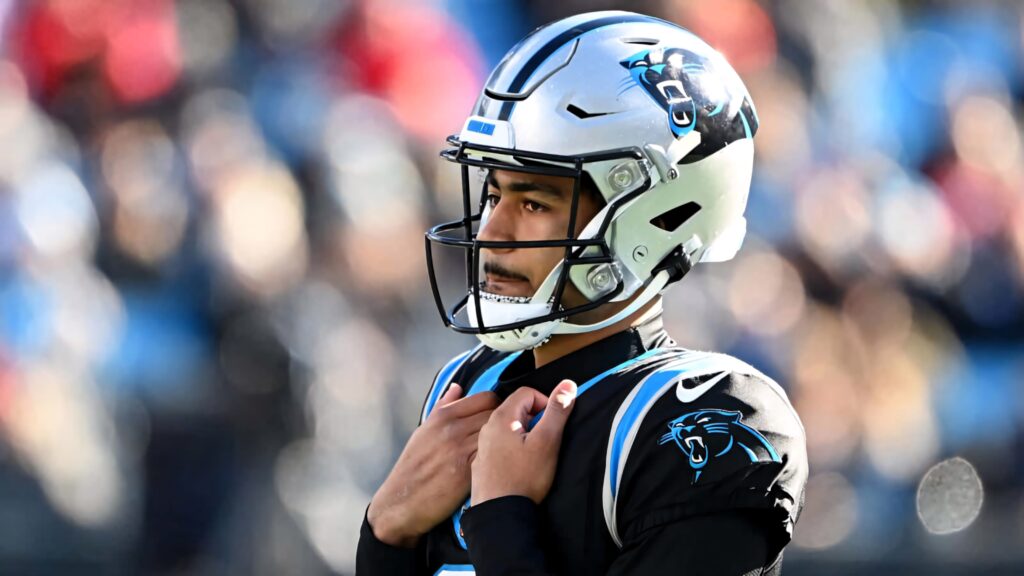 Bryce Young Panthers quarterback in Carolina Panthers uniform with blue helmet on football field Wallpaper