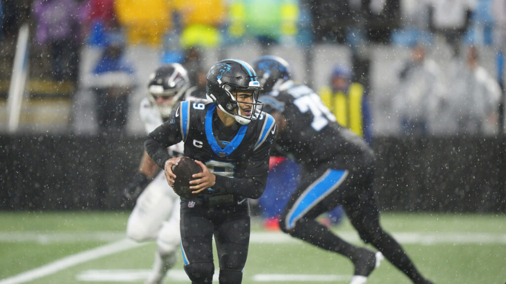 Bryce Young Panthers quarterback intense rain game action vibrant uniform stadium background wallpaper