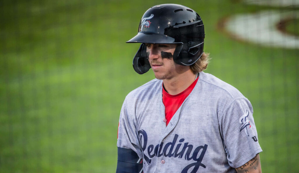 Bryson Stott baseball portrait in uniform with helmet and eye black on vibrant stadium field Wallpaper