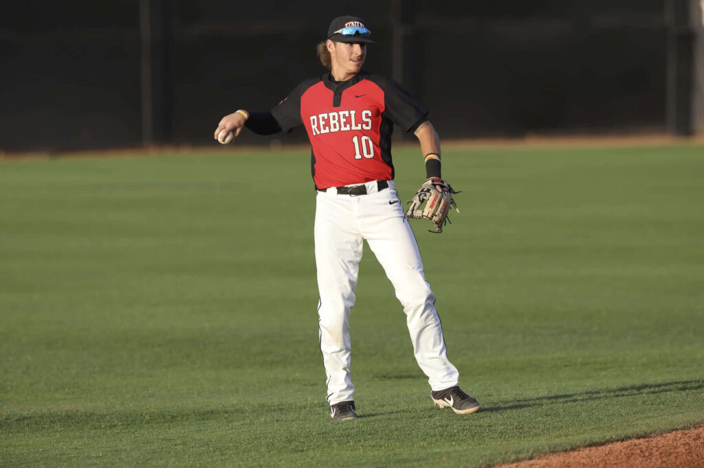 Bryson Stott baseball infielder fielding action Rebels10 uniform vibrant red black on green field Wallpaper