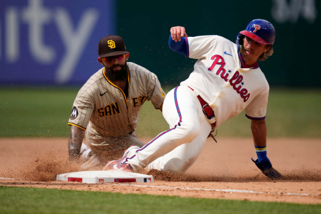 Bryson Stott slides into second base against Padres infielder bright daylight Phillies baseball action Wallpaper