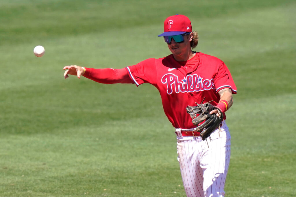 Bryson Stott Phillies player fielding baseball throwing on vibrant green MLB sports wallpaper background