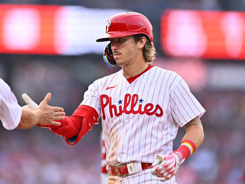 Bryson Stott Phillies fist bump celebration mid-action red white pinstripes MLB baseball wallpaper