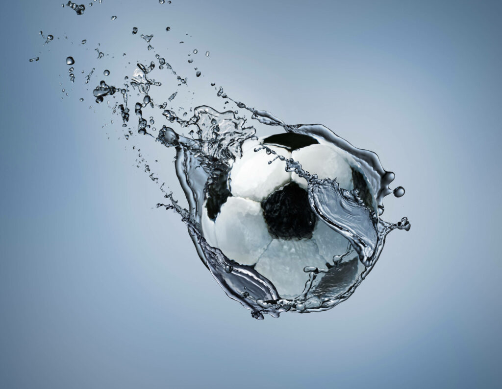 A Bubble-Filled Aquatic Scene: Submerged Football Creates a Mesmerizing Underwater World Wallpaper