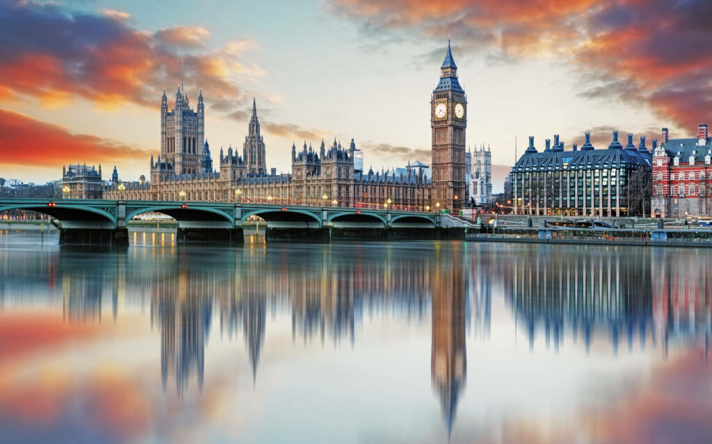 Buckingham Palace at sunset with colorful clouds reflecting in water serene majestic wallpaper